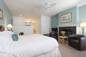 heritage room with bed, fireplace, chairs and spa tub