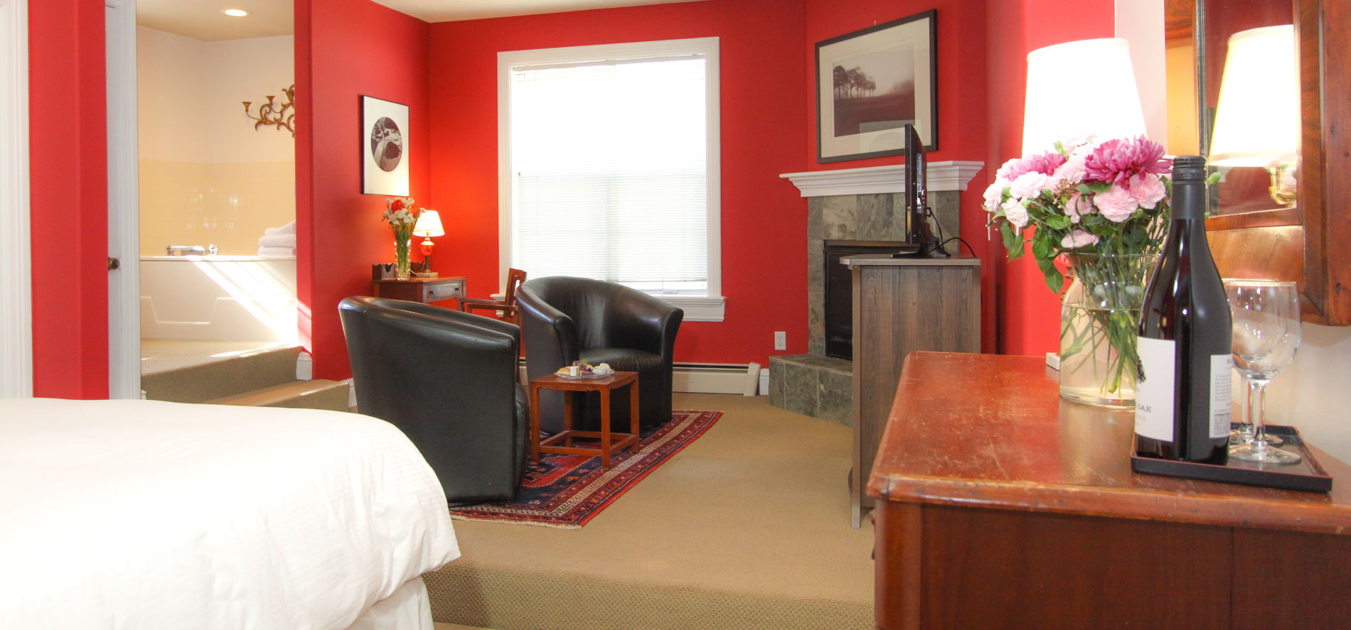 ruby with bed, chairs, spa tub and fireplace
